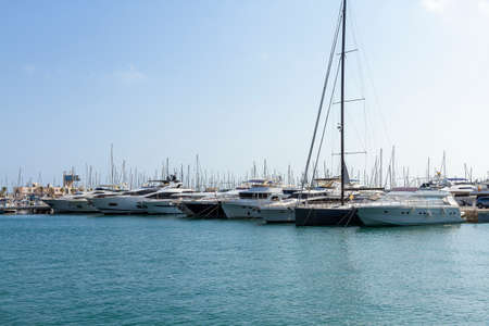 horizontal view of some boats docked in the marina