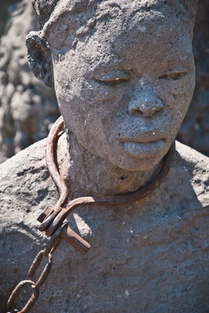 Statue of a woman in slavery posed in Stone Town, Zanzibar, where once was placed the slave market.の写真素材
