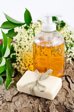 bar of soap and liquid cleanser with elderberry flowersの写真素材