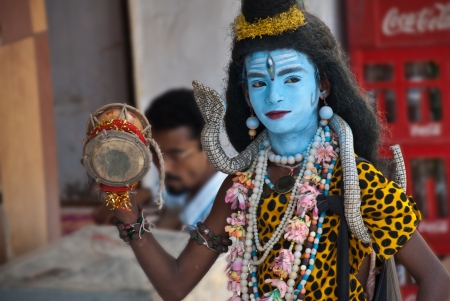 Udaipur, India, August 18, 2008: young man performing on the street dressed up like God Shiva. This...