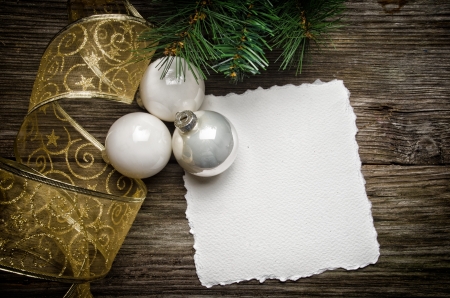 Christmas greeting card with white ornaments and golden ribbonの写真素材