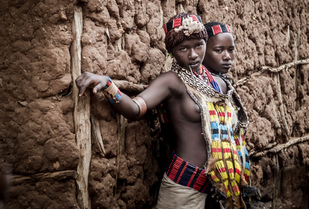 Turmi, Ethiopia - August 11 2014: two unidentified women from Hamer tribe at the market in Turmi, on 11august 2014. The colorfull dresses of these wome mean that they are not yet merriedのeditorial素材
