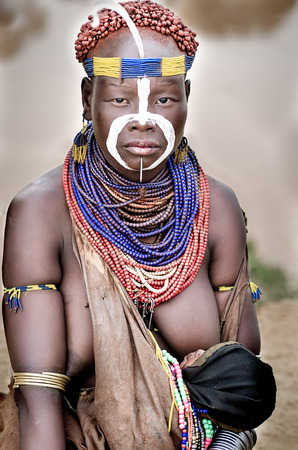 Kolcho, Ethiopia - August 12: unidentified woman from Karo tribe with her children in Kolcho, Ethiopia, 12 august 2014. Karo women paint their body with natural pigmentsのeditorial素材