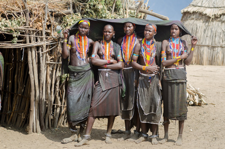 ARBORE, ETHIOPIA, 13 AUGUST: group of unidentified young women from Arbore tribe in Arbore, Ethiopia, on 13 august 2014. Arbore women use black veils to protect themselves from the sun and a lot of bead necklaces as personal decorationのeditorial素材