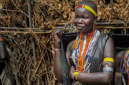 ARBORE, ETHIOPIA, 13 AUGUST:unidentified young woman from Arbore tribe in Arbore, Ethiopia, on 13 august 2014. Arbore women use black veils to protect themselves from the sun and a lot of bead necklaces as personal decorationのeditorial素材