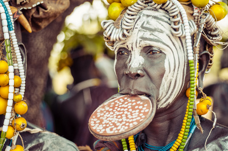 JINKA, ETHIOPIA, - 10AUGUST: unidentified woman from Mursi tribe with big lip Plate, in Mago National Park, Jinka Ethiopia, on 10 August 2014. In the Mursi tribe, the more the lip plate is big, the more the woman is considered beautifulのeditorial素材