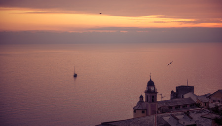 Pink shedes on the sea in front of Camogli, Italy, at sunsetの写真素材