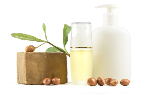 Cosmetic products and soap with argan fruits for skin care and hair on a white background. Space for labels and graphicsの写真素材