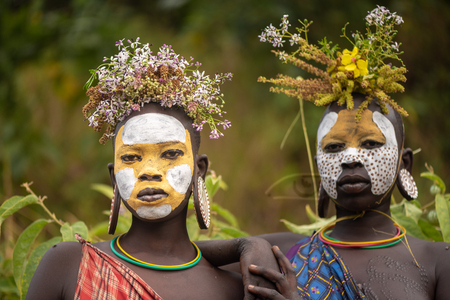 KIBISH, ETHIOPIA - AUGUST 22, 2018: unidentified women from Surmi tribe, with flower decorations. Surmi are also called Suri or Surma and live in villages in the south wester part of Ethiopiaのeditorial素材
