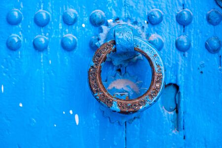 Knocker on a blue doorの写真素材