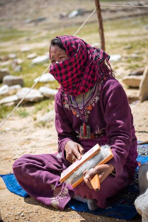Woman carding wool fibers in Ladakhのeditorial素材