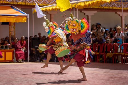 MBuddhist monks with traditional masks performing ritual dancesのeditorial素材