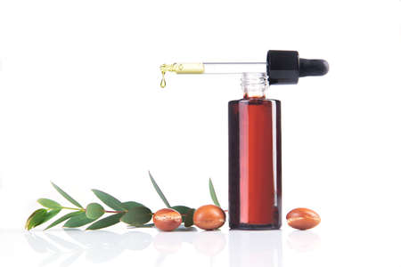 Bottle of argan oil on whiteの写真素材
