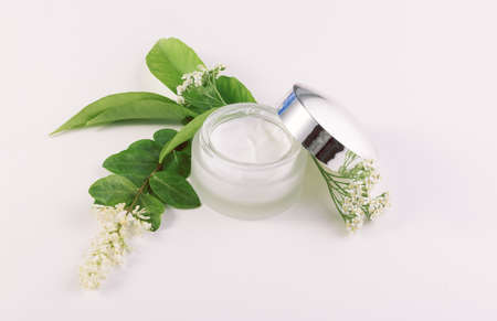 jar of cream for skincare with herbs and flowersの写真素材