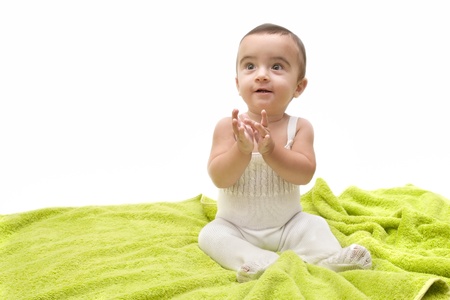 beautiful baby with the green towel on white background の写真素材