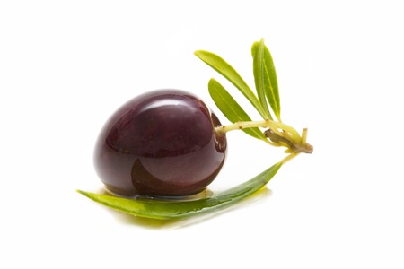macro of a fresh olives bathed in olive oil on white backgroundの写真素材