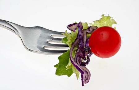 a bite of salad  isolated on a white backgroundの写真素材