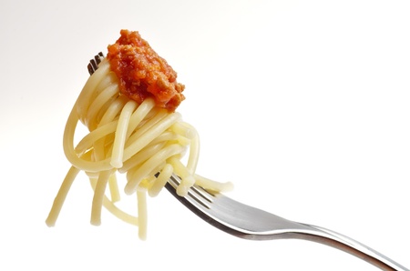  eating spaghetti bolognese isolated on a white backgroundの写真素材