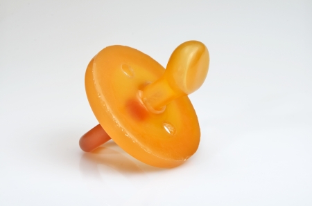 macro photograph of a silicone pacifier on white background