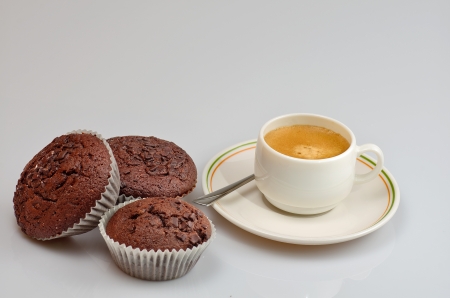 photo of three chocolate muffins and a coffeeの写真素材