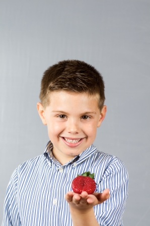 
portrait photograph of a child eating strawberriesの写真素材