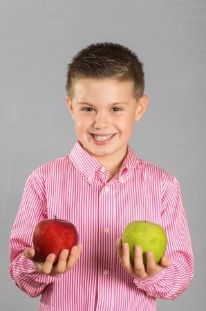 photograph of a child posing with apples variedの写真素材