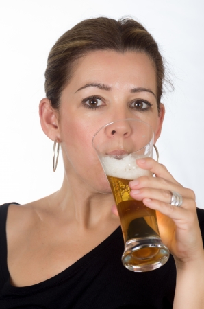 portrait of a woman drinking beer on white backgroundの写真素材