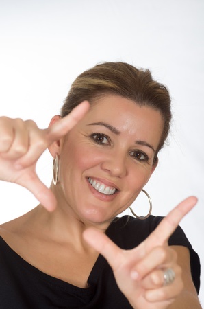 real woman framing itself for photo on white backgroundの写真素材