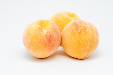 macro photography of three peaches on white backgroundの写真素材