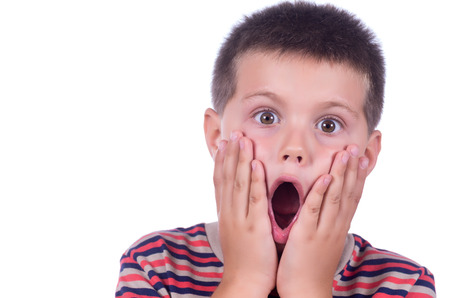 photograph of a amazed boy on a white backgroundの写真素材