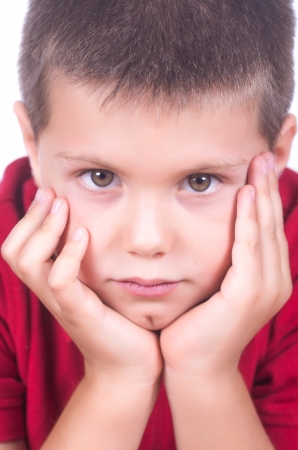 photograph of a child with red sweater posing on white backgroundの写真素材