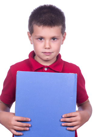 photographic portrait of a schoolboy with red sweater and a blue folder on a white backgroundの写真素材