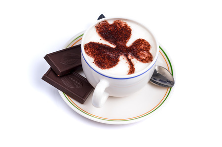 macro photograph of a cup of coffee with milk chocolate and decorated with chocolate accompanied with twoの写真素材