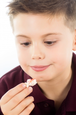 photographic portrait of a boy eating some delicious popcornの写真素材