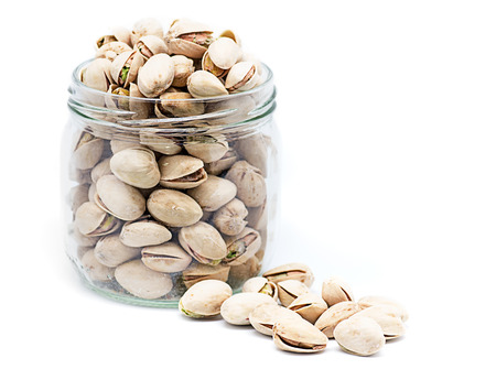 product photography a jar full of pistachios on white background glassの写真素材