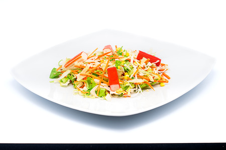 a bite of salad  isolated on a white backgroundの写真素材