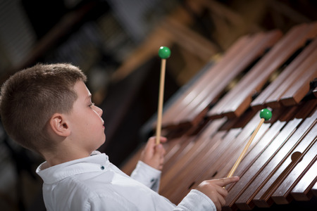 portrait of a young man learning to play the xylophoneの写真素材