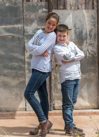 Portrait photograph of two children posing in a foreign locationの写真素材