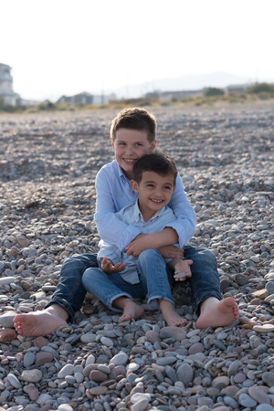 Sign up portrait of two children on beachの写真素材