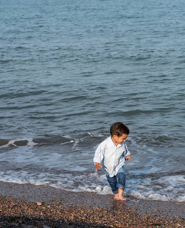 Sign up portrait of two children on beachの写真素材