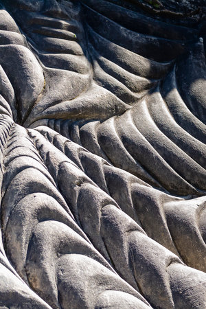 Unique textures and patterns formed on a stone surface show the effects of natural erosion over...