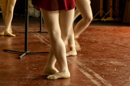 Young dancers enhance their skills with focused practice in a well-lit studio during the evening.の写真素材