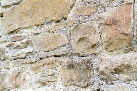 Weathered stones blend seamlessly, telling a story of time and nature in a serene outdoor...