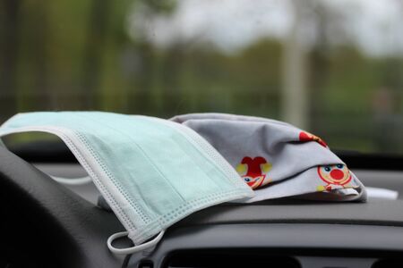 Mouth protection on the dashbord in the carの写真素材