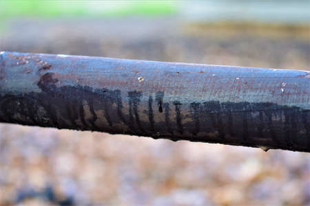 Close-up of a wooden black pasture fence against a blurred backgroundの写真素材