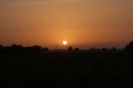 Landscape with wind turbines during a colourful sunset