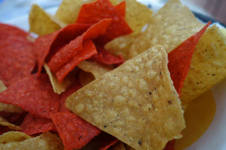 Orange and yellow nacho chips as a close up