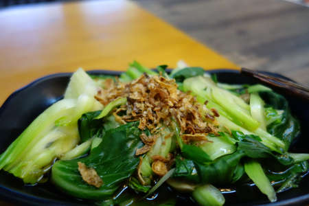 green vegetable on a black plate as a close upの写真素材