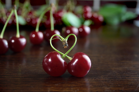 Sweet red cherries on a wooden tableの写真素材