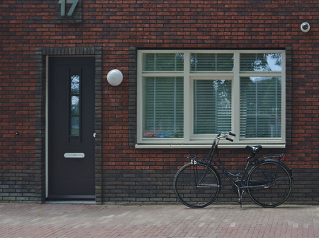 dutch bike under the windowの写真素材